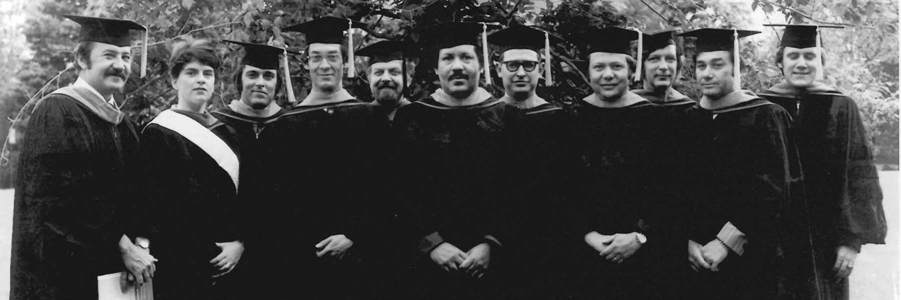 A vintage black and white photo of the school's first grads, with first Dean Bonser to the far left.