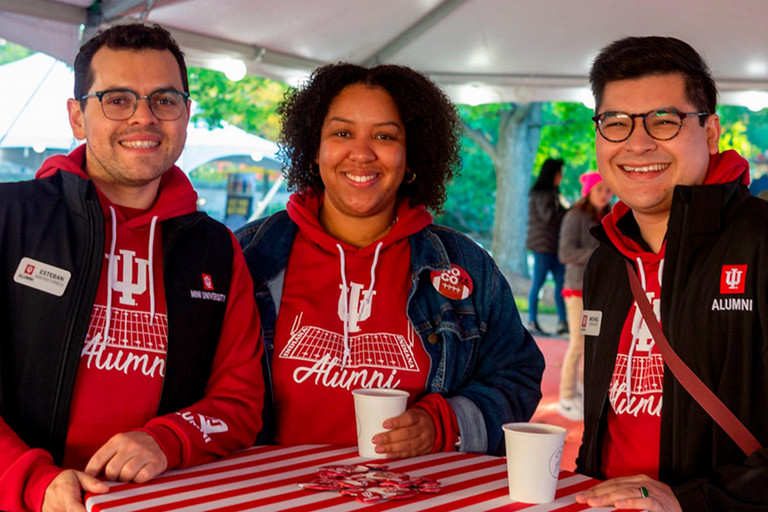 Three smiling alums