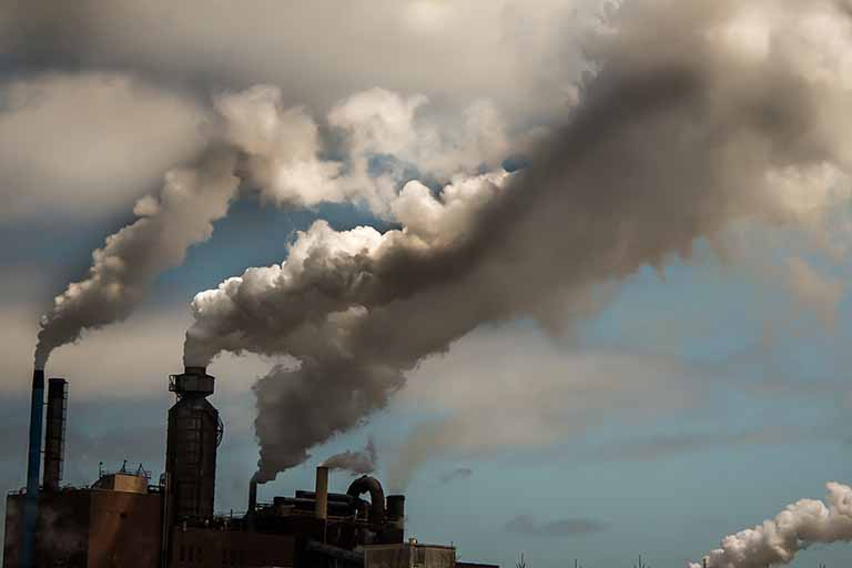 Smoke and steam billow from smoke stacks