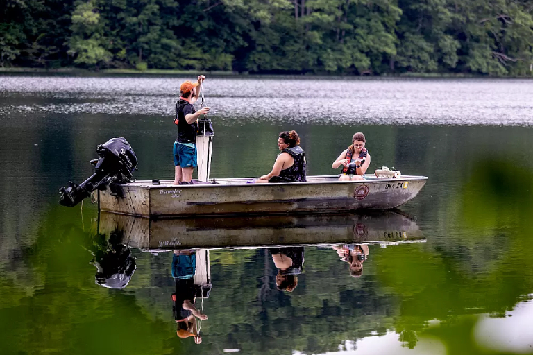 People in boat on Yellowwood Lake, testing water.