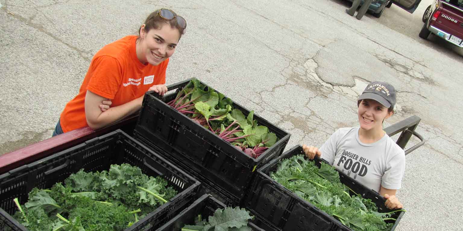 Students with home grown vegetables.