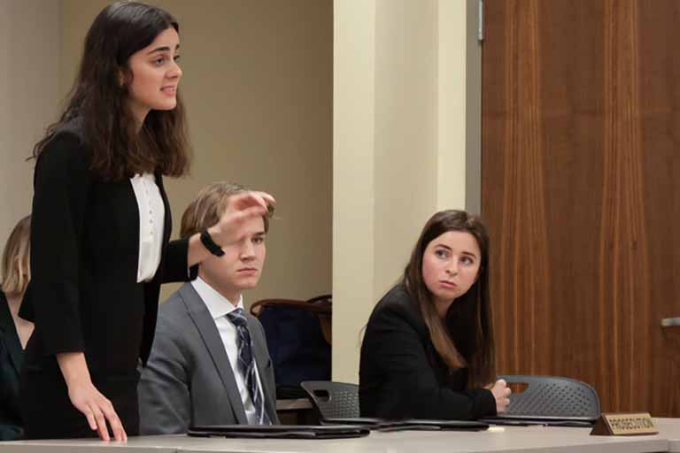 Three students present at mock trial
