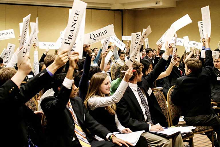 Students waive papers with country names