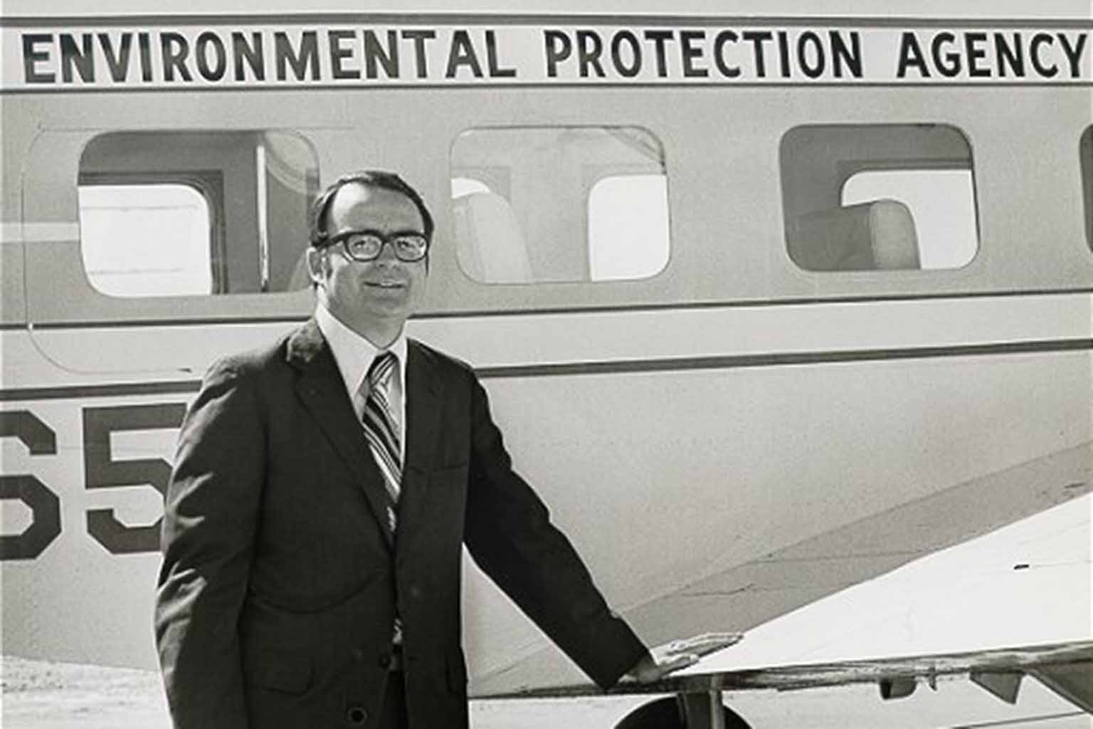 William D. Ruckelshaus in front of the EPA plane